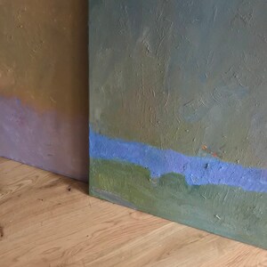 May include: Two abstract paintings with textured surfaces. The painting on the left is a gradient of brown, purple, and pink. The painting on the right is a gradient of green, blue, and purple.