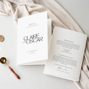 May include: Elegant wedding invitation with the names "Claire and Oscar" in black script. The invitation is white with black text, including the wedding date and location. A gold-colored wax seal and spoon are visible.