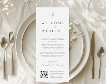 May include: A white wedding welcome card with black text. The card reads "Welcome to our Wedding." The card also includes a QR code and the text "Let's make memories. We would love to see the day through your eyes! Please upload your photos and videos to our shared album."