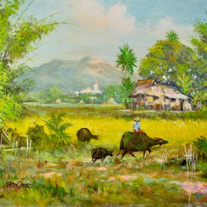 May include: A painting of a rural scene with a person riding a water buffalo through a field of yellow grass. There are trees and a small village in the background. The sky is blue with white clouds.