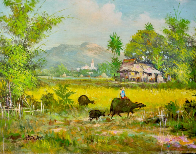 May include: A painting of a rural scene with a person riding a water buffalo through a field of yellow grass. There are trees and a small village in the background. The sky is blue with white clouds.