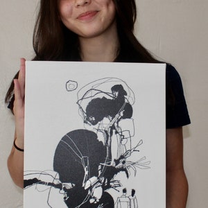 May include: A black and white abstract art print on canvas featuring a tree with a large black circle and two figures in the foreground. The artist's signature, "marioOrbito", is visible in the bottom left corner.