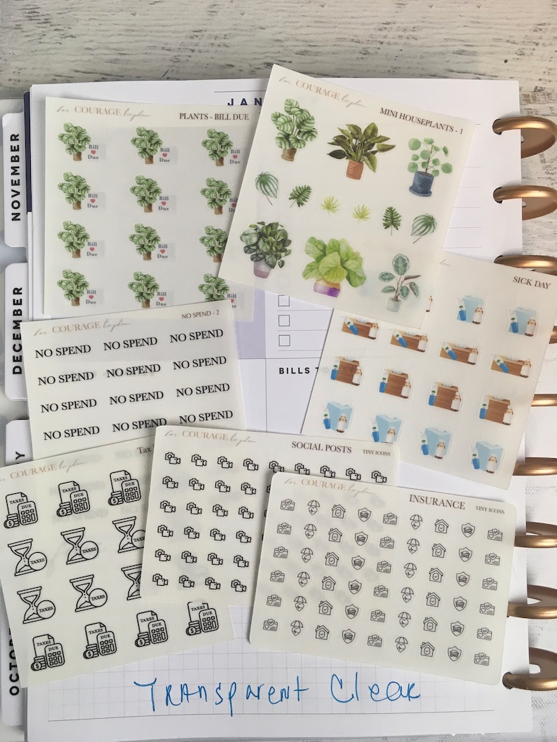 May include: A set of clear planner stickers with various designs, including plants, houses, taxes, social media icons, and insurance icons. The stickers are labeled with the text "Courage to Plan" and "Tiny Icons".