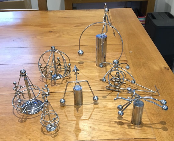 Genuine vintage 1970s/80s balancing metal figurines — real retro desk toys with 61 favorites and actual age/history behind them, not a reproduction.