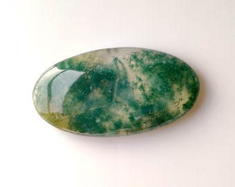 May include: A smooth, oval-shaped green moss agate stone with a white and green marbled pattern.
