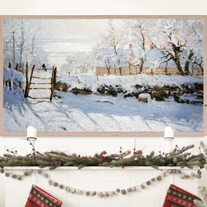 May include: A framed painting of a snowy winter scene with a small house and trees covered in snow. The painting is in a light wood frame and is hanging on a white wall.