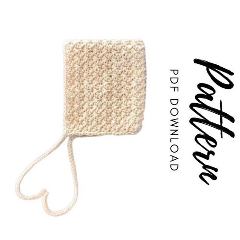 May include: A crochet baby bonnet pattern in beige with a heart-shaped tie. PDF download included.