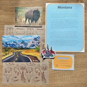 May include: A collection of Montana-themed stationery including a bison postcard, a mountain landscape print, a letter with the header Montana, a floral sticker, a thank you note, and a sheet of translucent paper featuring brown line art of boots and bison.