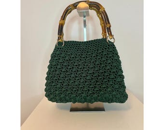 Handmade crochet drawstring bag with a leather base and bamboo handles. Handcrafted in Italy.