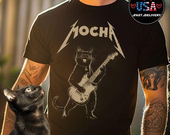May include: Black t-shirt with a graphic of a black cat playing an electric guitar. The text "MOCHA" is above the cat.