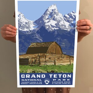 May include: A vintage-style poster featuring a scenic view of the Grand Teton National Park in Wyoming. The poster depicts a rustic wooden barn in the foreground with snow-capped mountains in the background. The text "Grand Teton National Park" is displayed in blue lettering with the park logo and the tagline "Youngest Range in the Rocky Mountains" and "Exposed Rock 2.7 Billion Years Old".