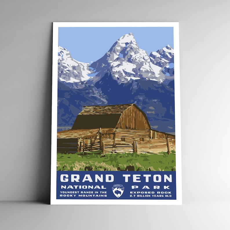May include: A vintage-style poster featuring a scenic view of the Grand Teton National Park in Wyoming. The poster depicts a rustic wooden barn in the foreground with snow-capped mountains in the background. The text on the poster reads "Grand Teton National Park, Youngest Range in the Rocky Mountains, Exposed Rock 2.7 Billion Years Old."