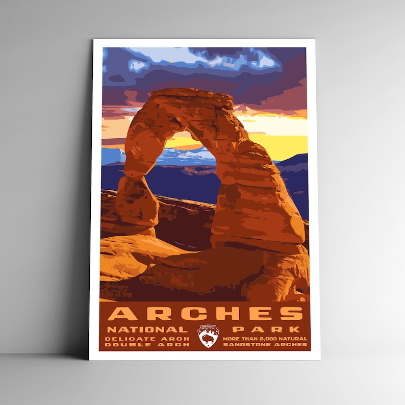 May include: A vintage travel poster for Arches National Park in Utah. The poster features a colorful illustration of Delicate Arch, a natural sandstone arch formation. The text on the poster reads "Arches National Park", "Delicate Arch Double Arch", and "More than 2,000 Natural Sandstone Arches".