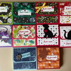 May include: Ten colorful card pockets with a variety of patterns and designs. Each pocket has a small tag that says "Just a note..."