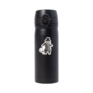 May include: Black stainless steel water bottle with a sticker of a possum wearing a top hat and holding a cane.
