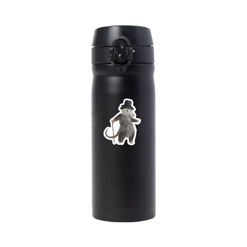 May include: Black stainless steel water bottle with a sticker of a possum wearing a top hat and holding a cane.