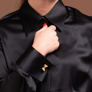 Close-up of Women's Black Silk Blouse with French Cuffs and Hidden Button
