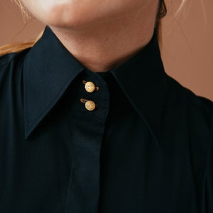 Discover elegance in our Black French Cuff Shirt on Etsy. Crafted from stretch fabric for a slim fit, this dress shirt features French cuffs, a high collar, and gold buttons. Elevate your formalwear with this versatile black blouse for cufflinks.