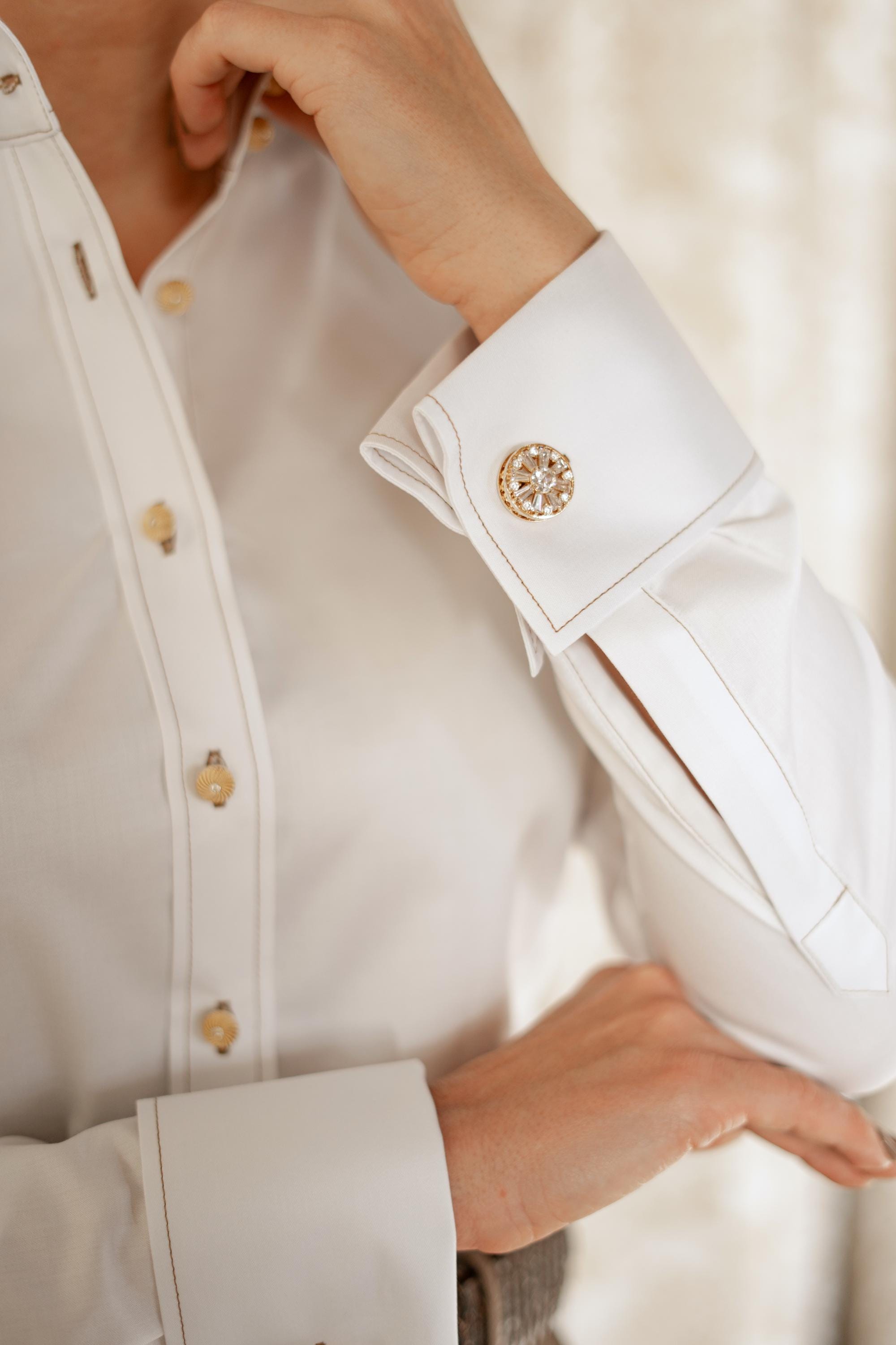 white dress shirt with gold buttons This creamy white shirt is a lightweight garment, fitted with gold buttons and shoulder pads that give it an exaggerated structure Shop our tops and shirts over at the link in