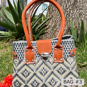 May include: A gray and white woven handbag with a brown leather handle and a silver clasp. The bag has a geometric pattern and the text "BAG #3" is visible on the bottom right corner.