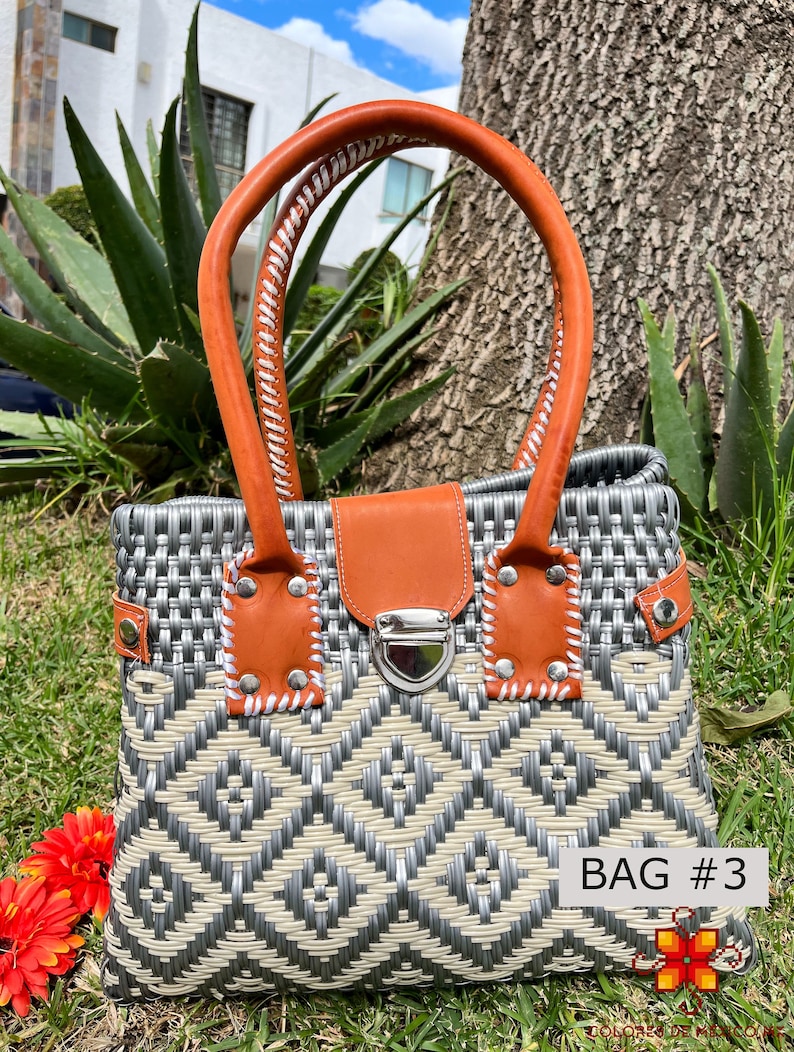 May include: A gray and white woven handbag with a brown leather handle and a silver clasp. The bag has a geometric pattern and the text "BAG #3" is visible on the bottom right corner.