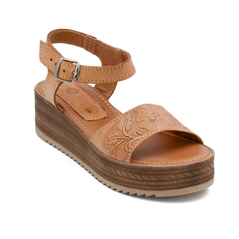 Peut inclure: Sandales en cuir tann&eacute; avec un motif floral et une &eacute;paisse semelle plateforme. Les sandales ont une bride &agrave; la cheville avec une boucle.