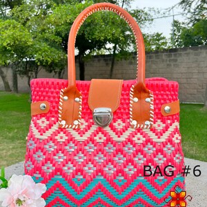May include: A pink, white, and turquoise woven handbag with a brown leather handle and a silver clasp. The bag has a geometric pattern and the text "BAG #6" is visible on the bottom right corner.