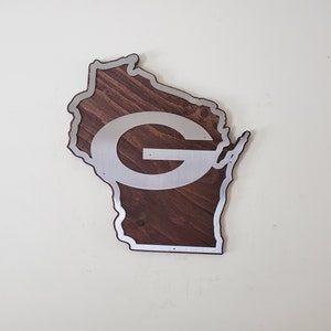 Angled view of the curved wall decor showing the silver steel border and the dark brown stained wood base on a light background.