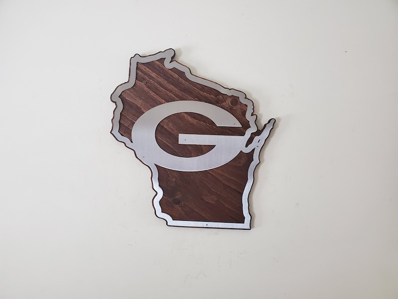 Angled view of the curved wall decor showing the silver steel border and the dark brown stained wood base on a light background.