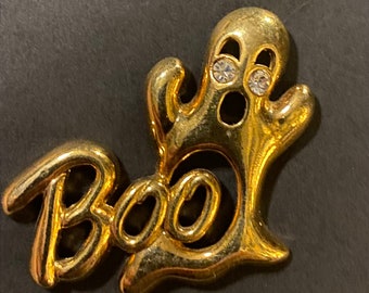Prendedor de solapa BOO en tono dorado vintage de Avon con ojos de diamantes de imitación