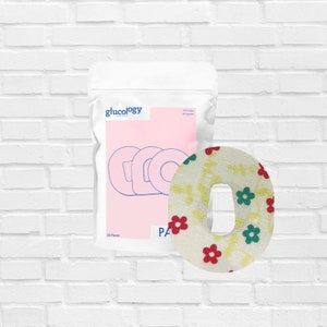 May include: A pack of 25 white fabric adhesive patches with a floral pattern in red, yellow, and green. The patches are designed to cover and protect medical devices like continuous glucose monitors. The packaging features the brand name "glucology" and the text "95% Cotton 5% Spandex".
