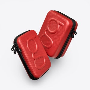 May include: Two red hard-shell cases with black zippers and the letters "gg" embossed on the front.
