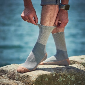 May include: A pair of gray socks with a light brown trim. The socks are made of a soft, comfortable material and are perfect for everyday wear.