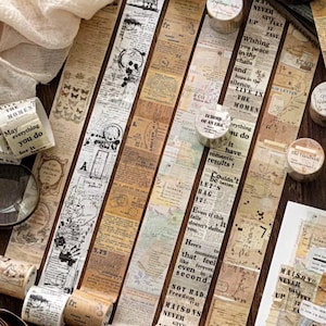 May include: Decorative washi tape rolls and strips with vintage newspaper and ephemera designs. The tape features text, illustrations, and a variety of colors, including beige, brown, and white. Perfect for scrapbooking, journaling, and craft projects.
