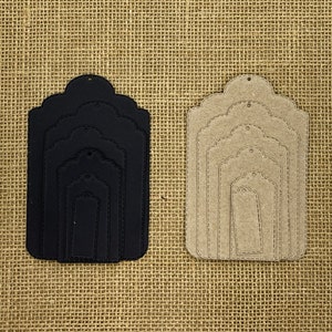 May include: Set of five nested, scalloped-edge gift tags in white, black, beige, and cream. The tags are made of cardstock and have a hole at the top for string or ribbon.