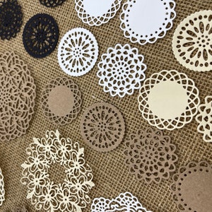 May include: Assortment of paper doilies in various sizes and designs. The doilies are white, cream, and brown with intricate lace patterns.