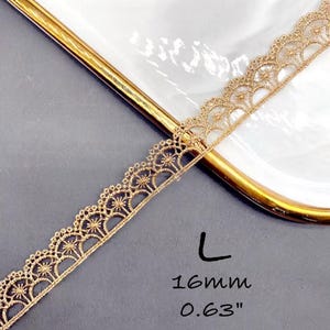 May include: Gold lace trim with a scalloped edge and a delicate floral pattern. The trim is 0.63 inches wide.