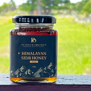 May include: A glass jar of Himalayan Sidr Honey, labelled "Platinum Organics Premium Health Foods" with a mountain range graphic and the text "Wild 250g".