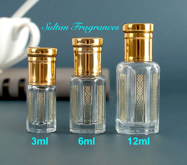 May include: Three glass bottles with gold caps and decorative gold designs. The bottles are labeled 3ml, 6ml, and 12ml.