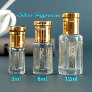 May include: Three glass bottles with gold caps and decorative designs. The bottles are labeled 3ml, 6ml, and 12ml. Sultan Fragrances is written above the bottles.