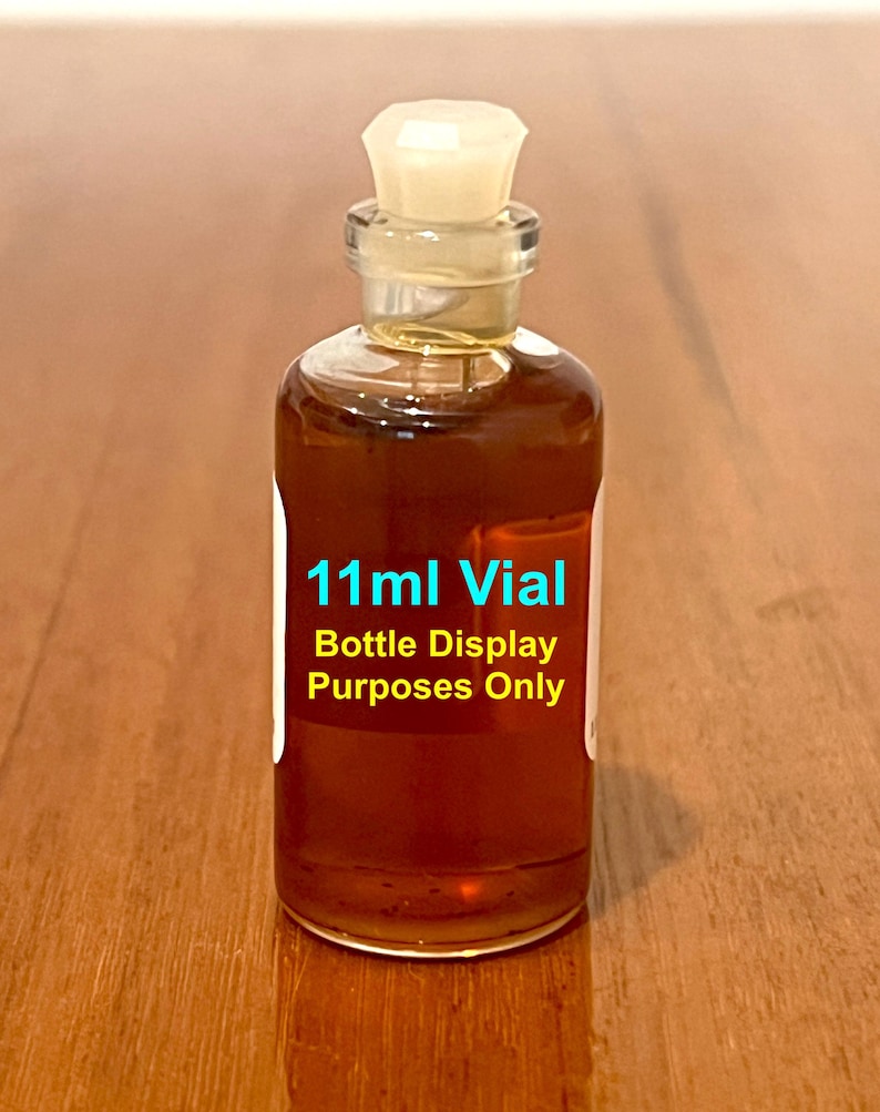 May include: A clear glass bottle with a white plastic stopper filled with a brown liquid. The bottle is labeled "11ml Vial Bottle Display Purposes Only".