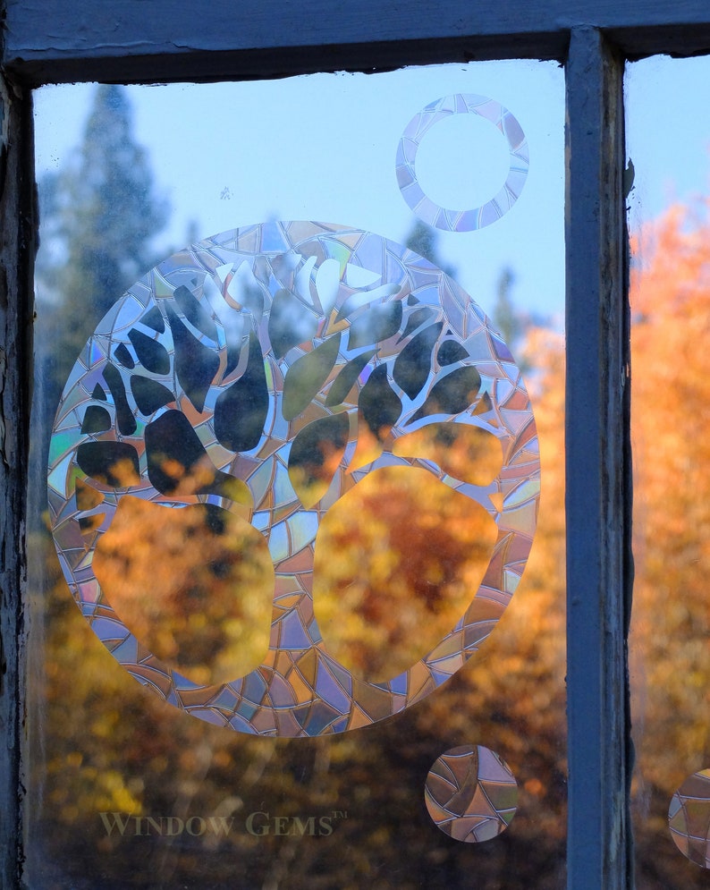 May include: A stained glass window with a tree design. The tree is made of many small pieces of glass in different colors. The window is set in a wooden frame. The text "WINDOW GEMS&trade;" is visible at the bottom of the image.
