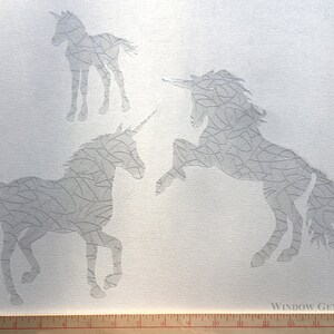 May include: Three white unicorn stencils on a white canvas background. The stencils are made of a thin, flexible material and have a delicate, intricate design. The stencils are perfect for creating unique and beautiful designs on walls, windows, and other surfaces.