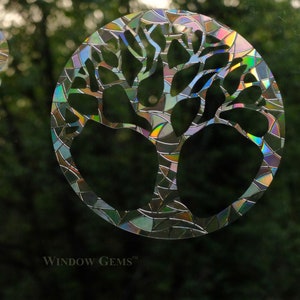 May include: A colorful, iridescent window cling featuring a tree design. The cling is made of a durable, weather-resistant material and is perfect for adding a touch of nature to any window. The cling is made by Window Gems.