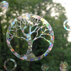 May include: A colorful iridescent window cling featuring a tree of life design. The cling is made of a durable, reusable material and is perfect for adding a touch of nature to any window. The cling is also a great way to add privacy to your home.