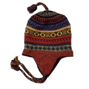 Another angle of the alpaca wool earflap hat laid flat, displaying its colorful design and tassel details.