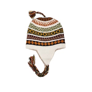 May include: A white knitted hat with a colorful geometric pattern and ear flaps. The hat has a long tassel.