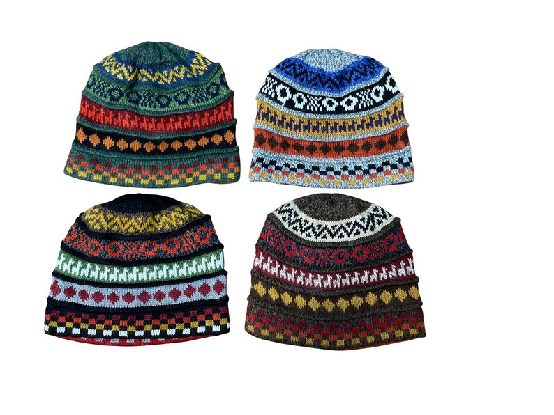 Pu&ograve; includere: Quattro berretti di lana colorati con motivi geometrici. Ogni berretto presenta una diversa combinazione di colori e un design diverso, tra cui strisce, rombi e lama.