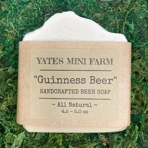 May include: A bar of handcrafted soap with a white top and a brown paper label. The label reads "YATES MINI FARM" and "Guinness Beer" with "HANDCRAFTED BEER SOAP" below. The soap weighs 4.5-5.0 oz and is labeled "All Natural".
