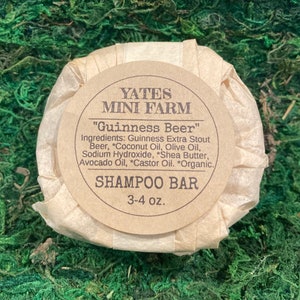 May include: A brown paper-wrapped shampoo bar labeled "Yates Mini Farm" with the text "Guinness Beer" and a list of ingredients including Guinness Extra Stout Beer, Coconut Oil, Olive Oil, Sodium Hydroxide, Shea Butter, Avocado Oil, Castor Oil, and Organic. The bar weighs 3-4 ounces.